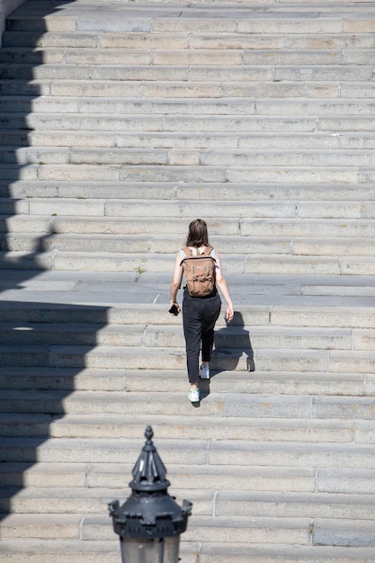 Gente caminando por escaleras de piedra con mochila