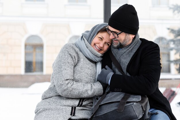 Foto gente feliz de tiro medio abrazándose en el banco