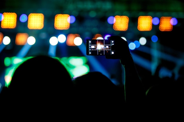 La gente hace fotos con su teléfono inteligente en conciertos