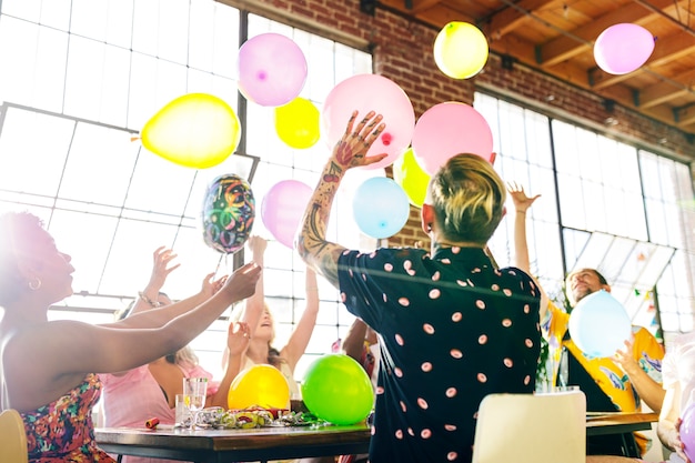 Gente jugando con globos en una fiesta.