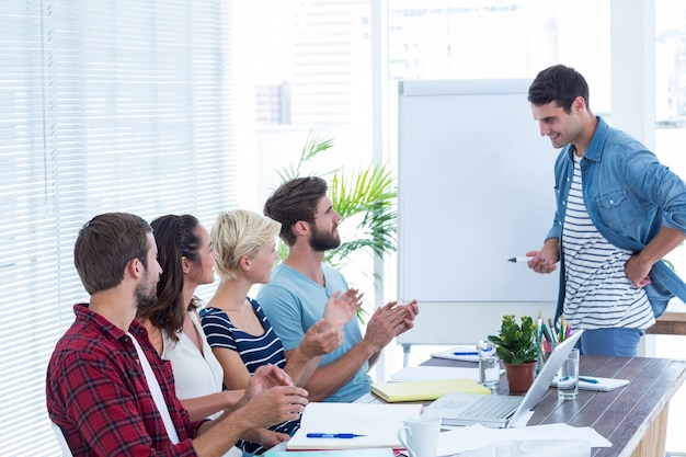 Gente de negocios informal aplaudiendo en la reunión