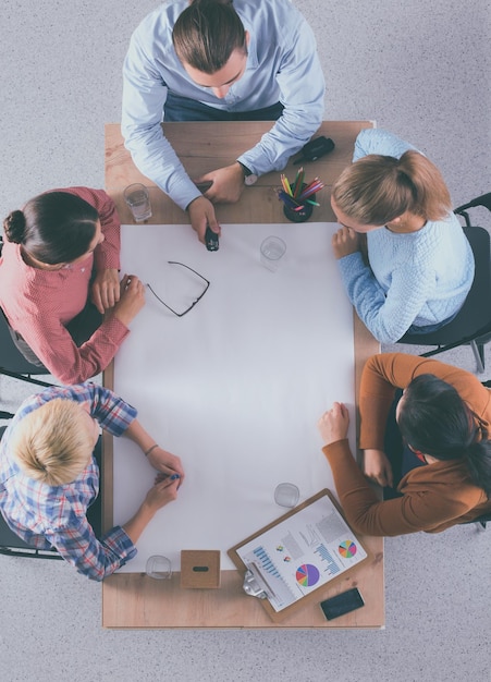 Foto gente de negocios sentada y discutiendo en una reunión en la oficina