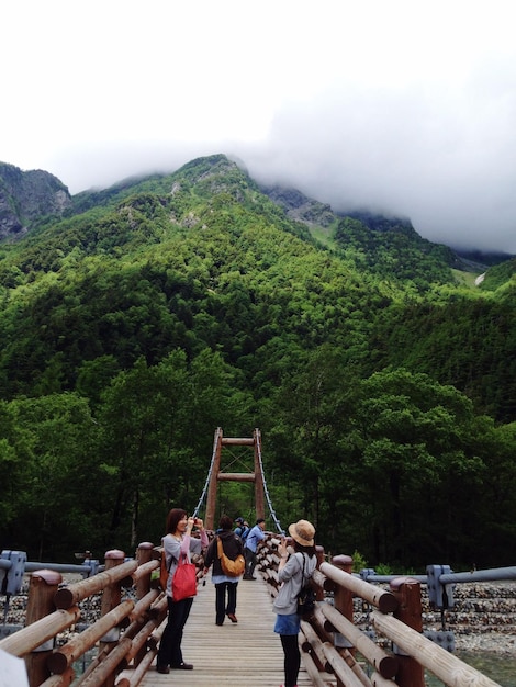 Foto gente en el puente en el parque nacional de kamikochi