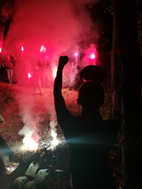 Foto la gente quemando fuegos artificiales por la noche