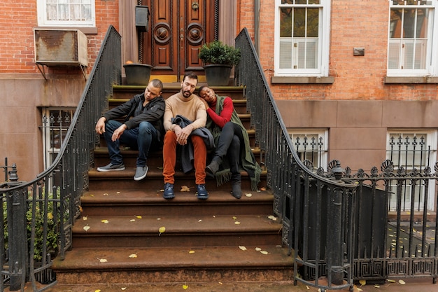 Gente de tiro completo durmiendo al aire libre en las escaleras