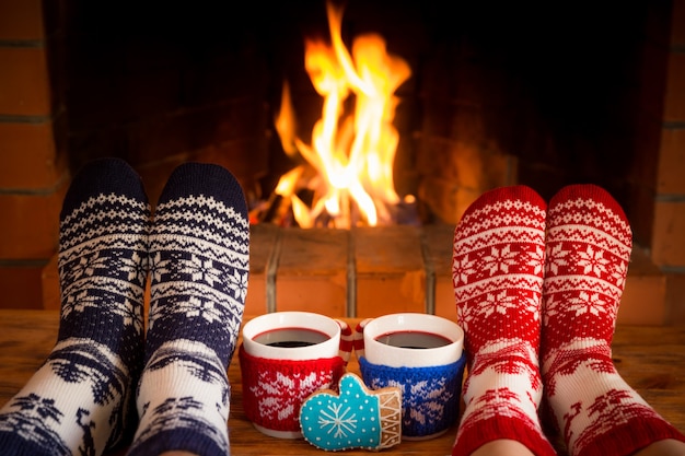 gente vistiendo calcetines de navidad cerca de la chimenea