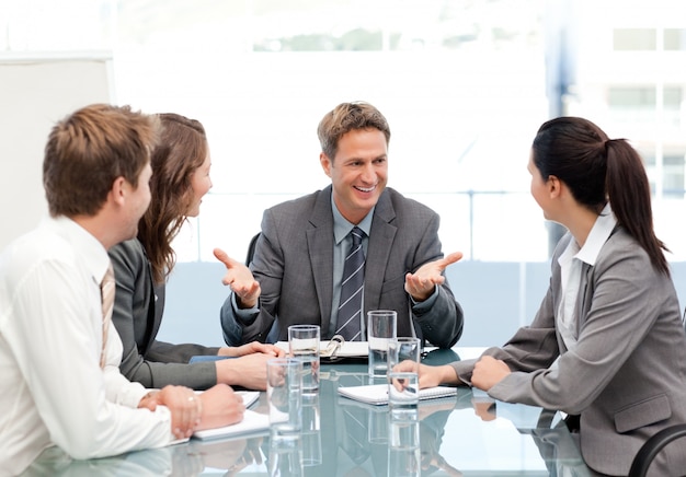 Gerente alegre falando com sua equipe em uma reunião