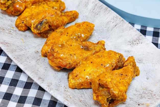 Foto gericht mit buffalo chicken wings auf einer schwarz-weiß karierten tischdecke