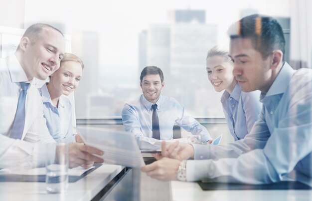 Geschäft, Menschen und Teamwork-Konzept - Gruppe lächelnder Geschäftsleute, die sich im Büro treffen