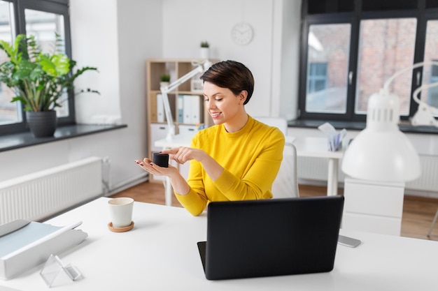 Geschäftsfrau benutzt einen intelligenten Lautsprecher im Büro