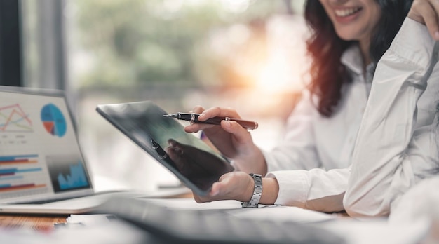 Geschäftsfrau Berater Geschäftsleute sprechen Planung analysieren Investitionen und Marketing auf dem Tablet im Büro