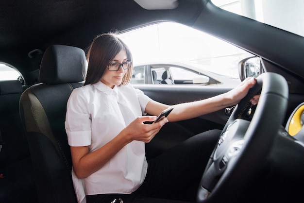 Geschäftsfrau, die im Auto am Telefon spricht