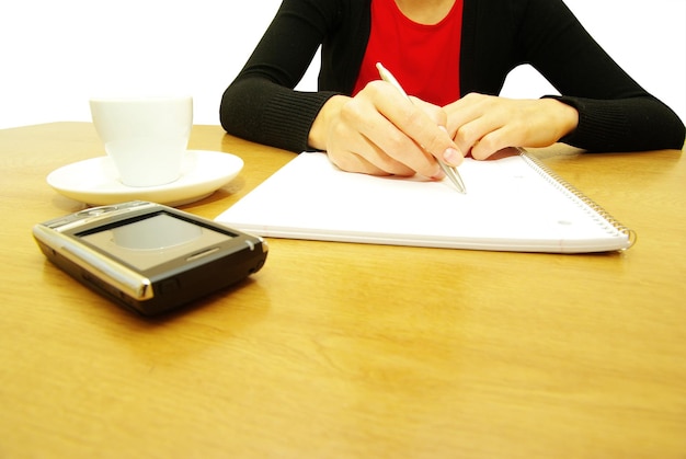 Geschäftsfrau schreibt einen Stift auf ein leeres Papier