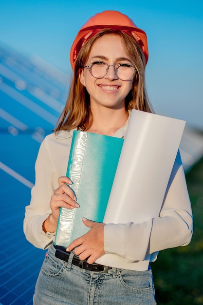 Geschäftsfrauen, die an der Überprüfung der Ausrüstung im Solarkraftwerk mit Tablet-Checkliste arbeiten Frau, die im Solarkraftwerk im Freien arbeitet