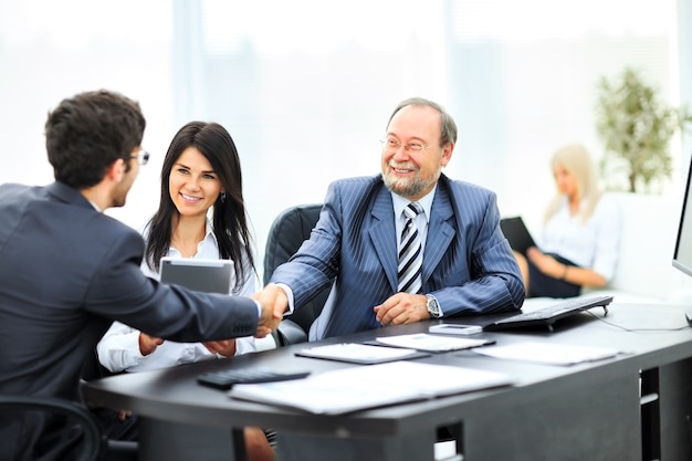 Geschäftsleute geben sich die Hand und beenden ein Meeting