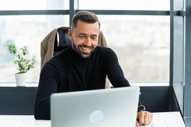 Foto geschäftsmann arbeitet im büro hinter einem laptop