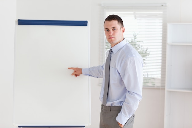 Geschäftsmann, der auf Flip-Chart zeigt