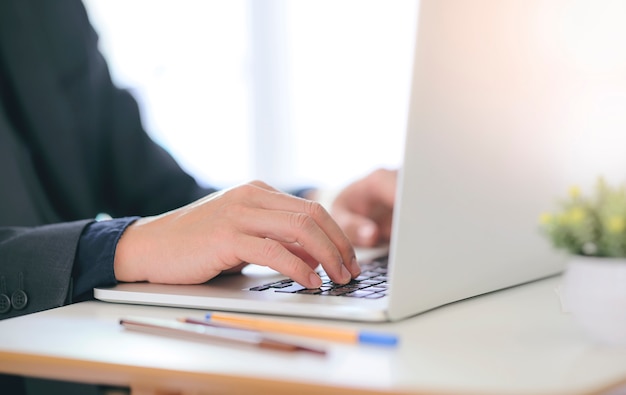 Geschäftsmann, der mit Laptop-Computer im Büro arbeitet.