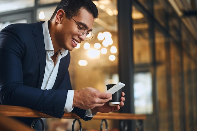 Geschäftsmann, der mit seinem Smartphone im Internet surft