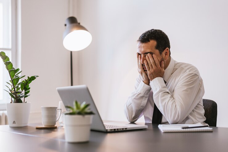 Foto geschäftsmann unter stress, müdigkeit und kopfschmerzen im büro