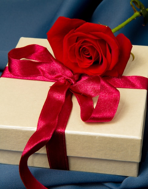 Geschenkbox und rote Rose