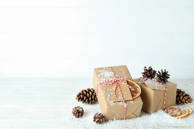 Geschenkboxen und Weihnachtsaccessoires auf weißem Holztisch