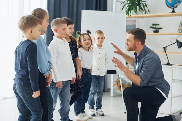 Geschichtenerzähler mit interessanten Informationen Gruppe von Kindern Schüler im Unterricht in der Schule mit Lehrer