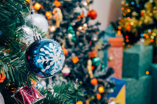 Geschmückter Weihnachtsbaum mit bunter Kugel auf funkelnden Bokeh-Licht unscharfem Hintergrund