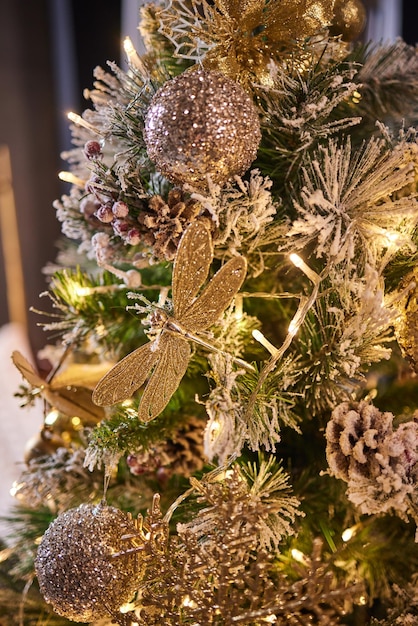 Geschmücktes Weihnachtsbaumgold auf unscharfem Hintergrund