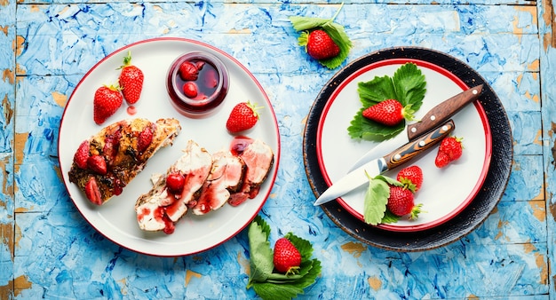 Geschnittene Hähnchenbrust mit Erdbeer-Beeren-Sauce auf dem Teller.Gegrillte Hähnchenbrust