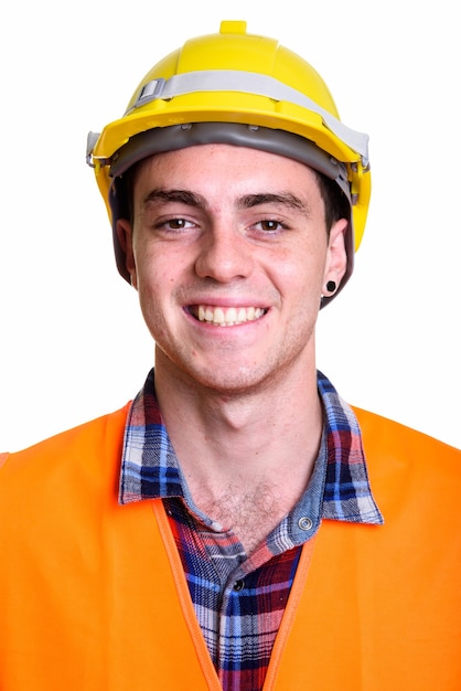 Gesicht des glücklichen jungen gutaussehenden Bauarbeiters lächelnd