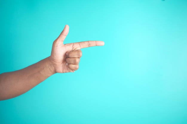 Gesto de la mano señalando con el dedo sobre un fondo azul con estilo minimalista y comunicación simbólica