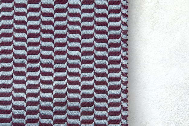 Gestrickte Textur Textur aus Jacquard-Stoff mit graublauem geometrischem Muster Gehäkeltes Mosaikmuster