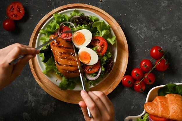 Gesunde Frau mit Besteck essen Salat