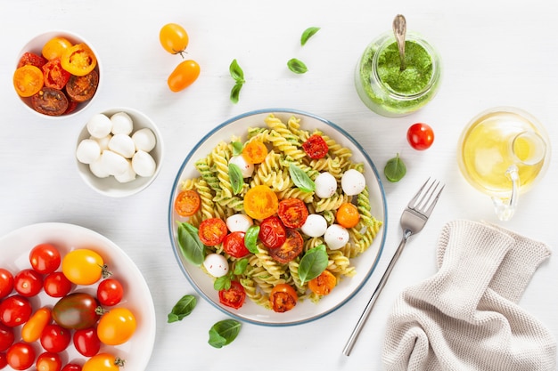 Gesunde Fusilli-Nudeln mit Pesto-Sauce, gerösteten Tomaten, Mozzarella