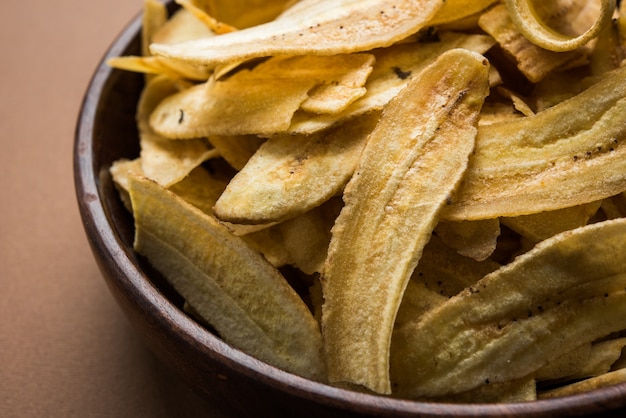 Gesunde hausgemachte Kela- oder Bananenchips oder Waffeln, serviert über stimmungsvoller Oberfläche, selektiver Fokus