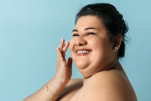 Gesunde Haut der hispanischen Frau in Übergröße. Lächelnde erwachsene Frau mit Hautpflege.