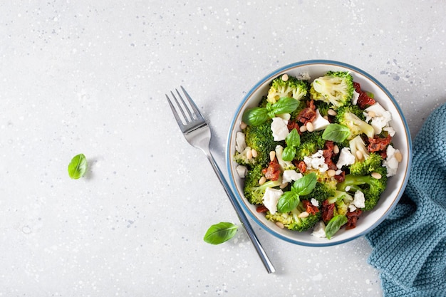 Gesunder Brokkolisalat mit Feta-Käse, sonnengetrockneten Tomaten, Pinienkernen, vegetarische Low-Carb-Keto-Diät