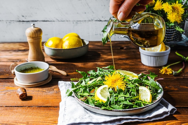 Foto gesunder löwenzahnsalat mit olivenöl, zitronensaft und gewürzen