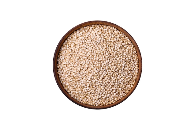 Gesundes rohes Quinoa in einer Schüssel auf dunklem Betongrund. Nützliches, gesundes Essen