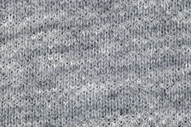 Getricktes graues Gewebe aus Fleece-Fäden mit gleichmäßigem Hintergrund