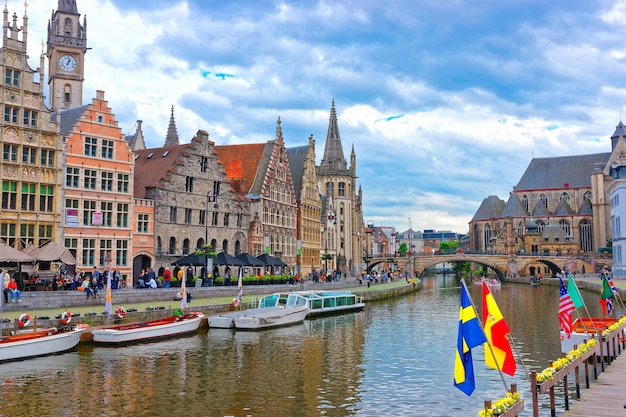 Ghent, Bélgica - 10 de maio de 2012: Guildhalls e torre do relógio da antiga estação de correios em Graslei em Ghent, Flandres Oriental, Bélgica. Pessoas no Canal do Rio Leie