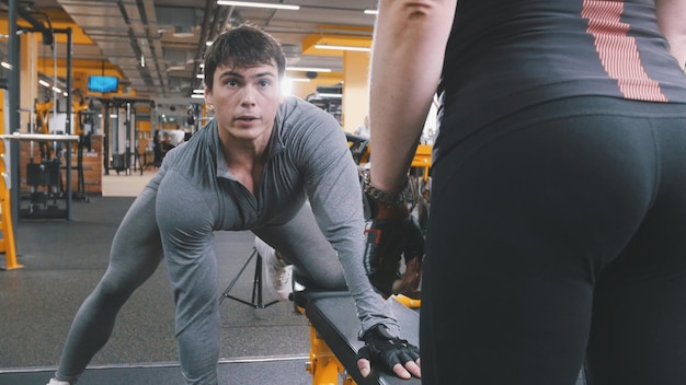 En el gimnasio - hombre musculoso atleta levantando pesas