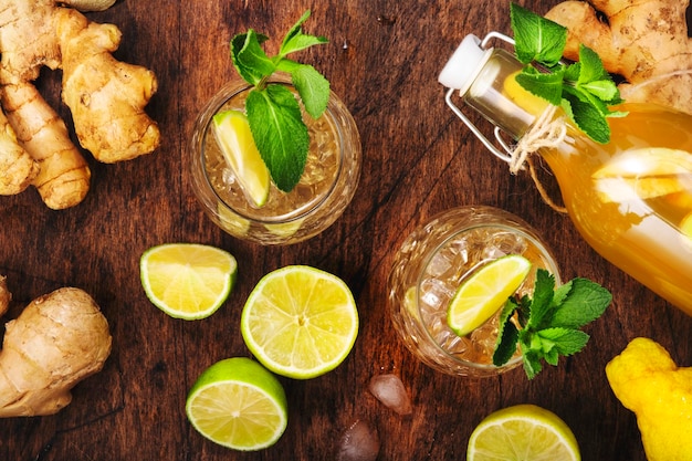 Ginger Ale Cocktail mit Bier Limette Zitrone und Minze in Glas auf Holztisch Draufsicht