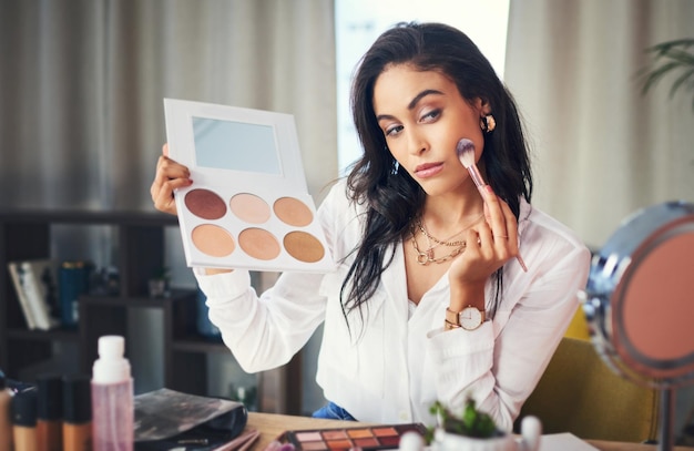 Girl influencer and recording with makeup at house for broadcast social media and live streaming Woman brush and cosmetic advice with content creation vlogging and podcast for beauty tutorial