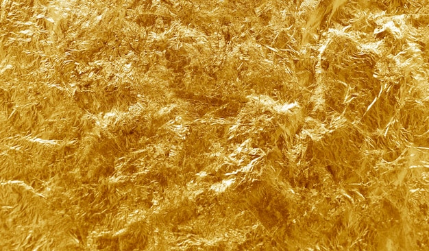 Glänzender gelber Blattgoldfolien-Texturhintergrund