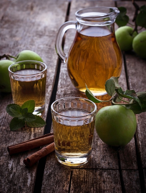 Gläser mit Apfelsaft auf Holztisch. Selektiver Fokus