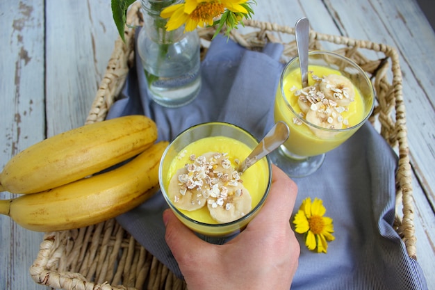 Gläser mit köstlichem Bananenpudding auf Behälter zum Frühstück