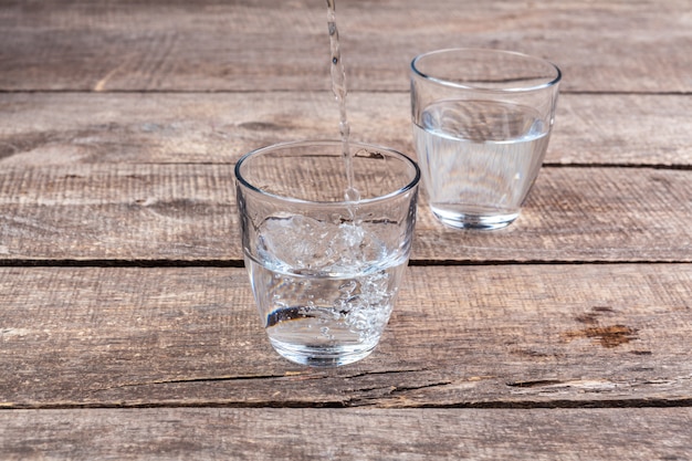 Gläser Wasser auf einem Holztisch.