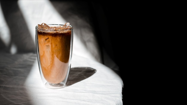 Glas Eiskaffee mit Milch auf dem Tisch